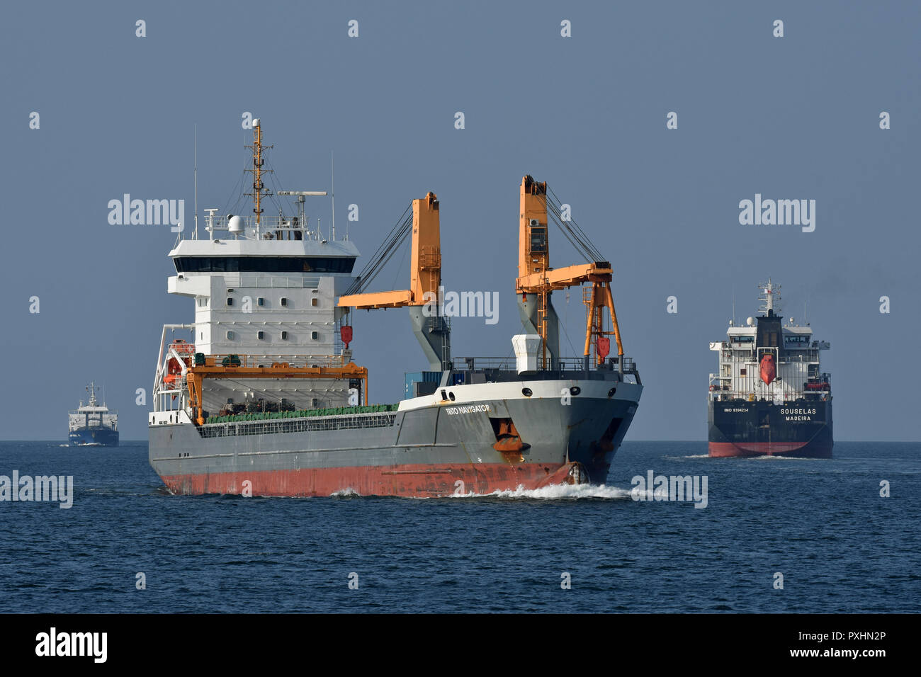 3 general cargo vessels navigating the Kiel fjord: John-Paul K, Trito Navigator, Souselas Stock Photo