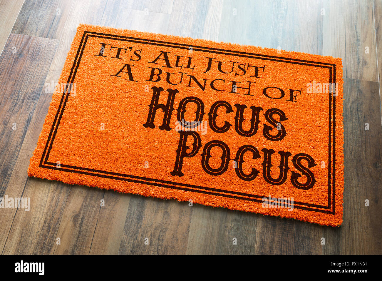 It's All A Bunch Of Hocus Pocus Halloween Orange Welcome Mat On Wood Floor Background. Stock Photo