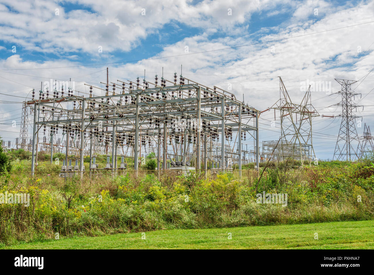 Horizontal shot of an Electric Power Grid Station under cloudy skies. Stock Photo