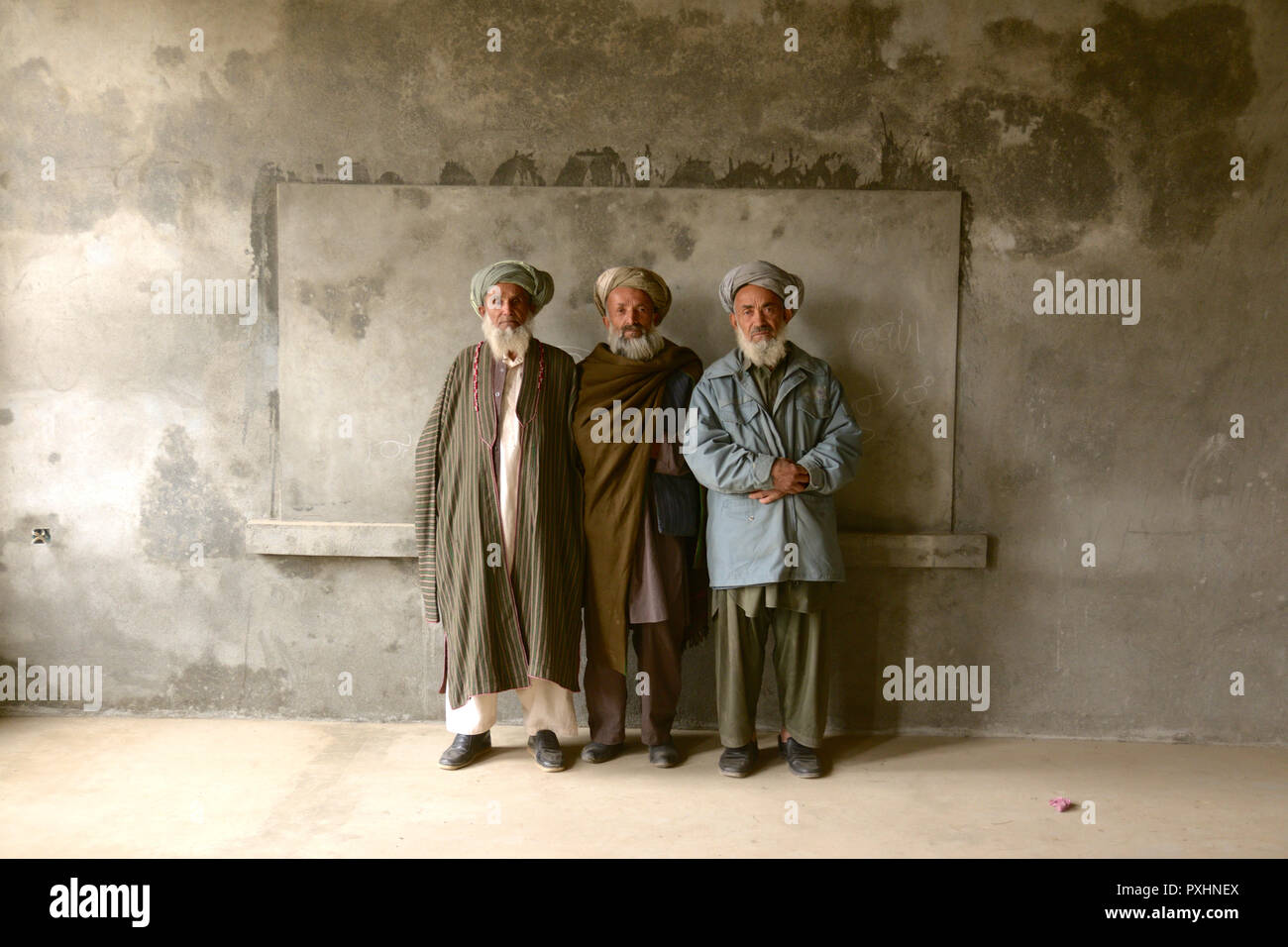 Three headmasters in the Rustaq District of Afghanistan stand in front ...