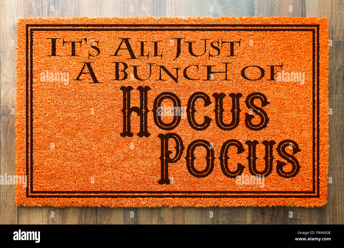 It's All A Bunch Of Hocus Pocus Halloween Orange Welcome Mat On Wood Floor Background. Stock Photo