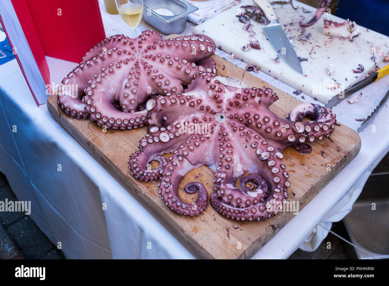 Large Cooked Octopus On Wooden Board Being Cut Up For Customers At The Dartmouth Food Festival In Devon Stock Photo Alamy