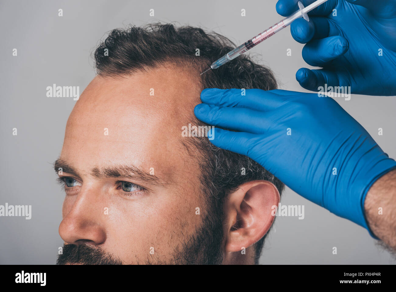Doctor giving shot to man hi-res stock photography and images - Alamy