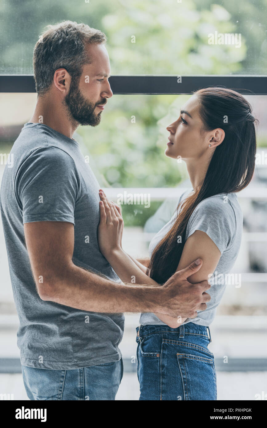 Side profile of a couple looking at each other Stock Photo - Alamy