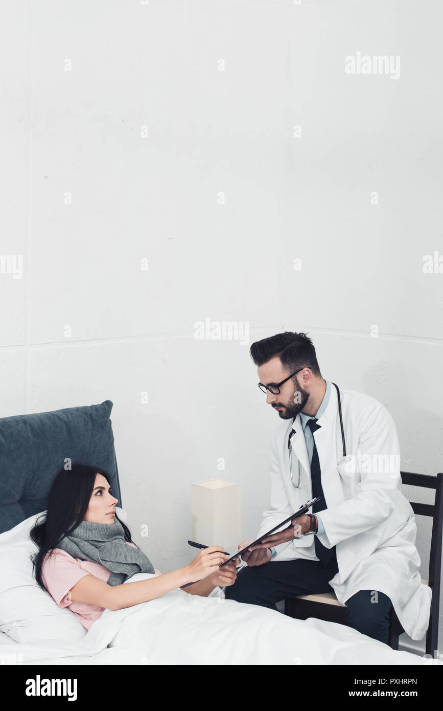 Doctor giving patient documents hi-res stock photography and images - Alamy