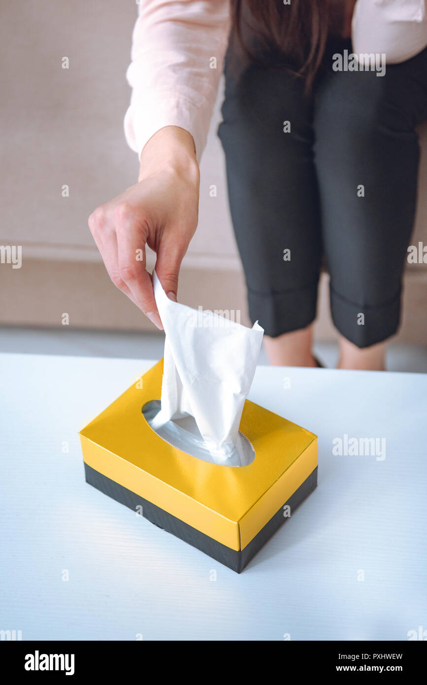 cropped shot of woman taking paper napkins from box Stock Photo