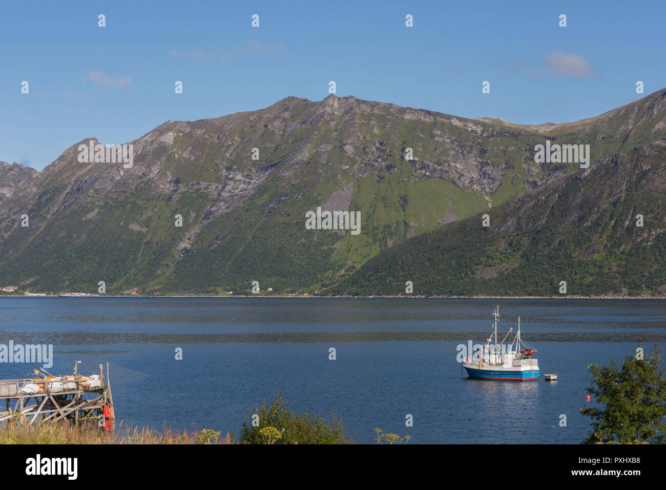 Fishing boat at anchor in fjord Stock Photo - Alamy