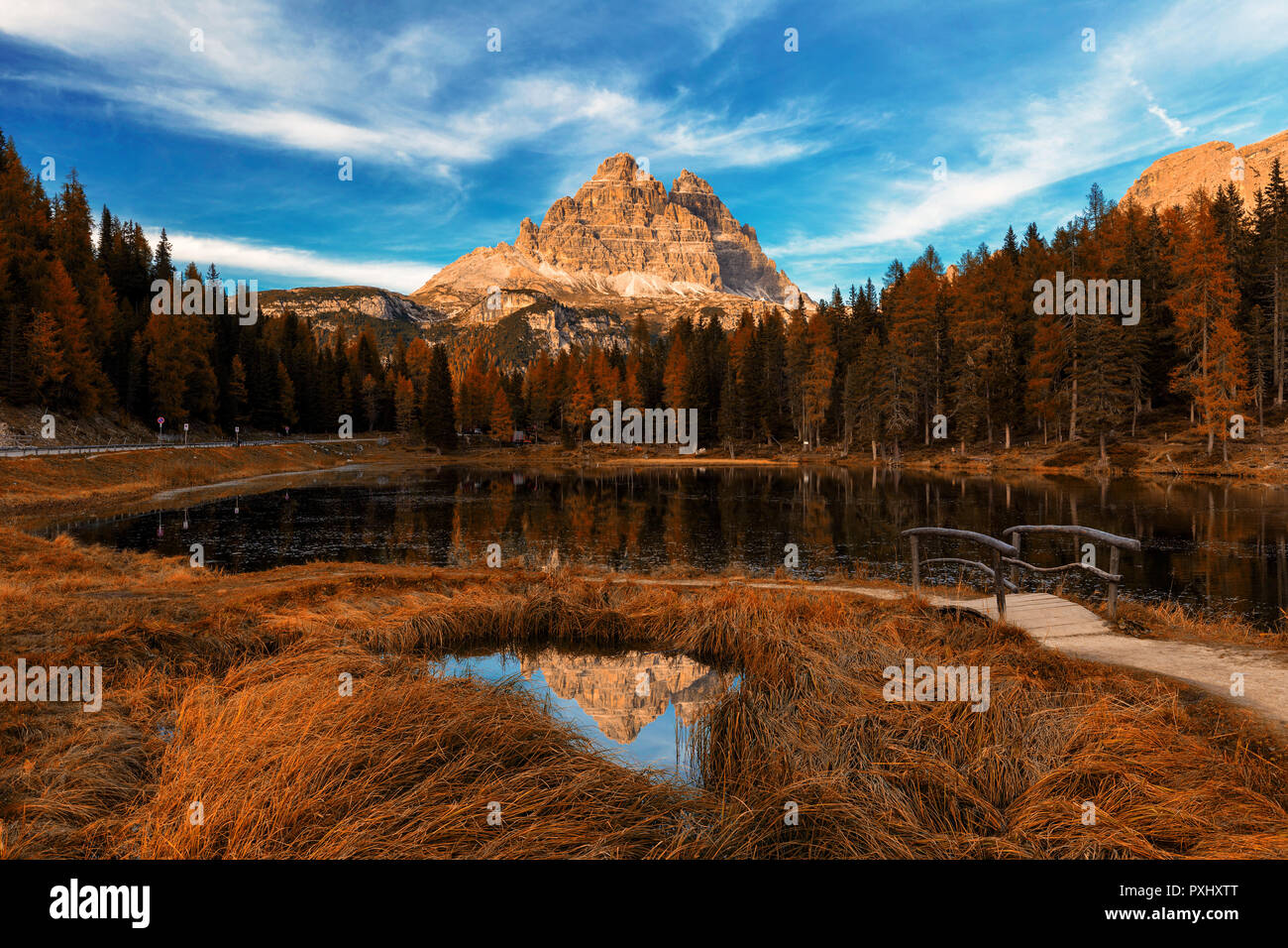 Antorno lake during late autumn with red leaves and tre cime reflection. Italy, Dolomites, Europe Stock Photo