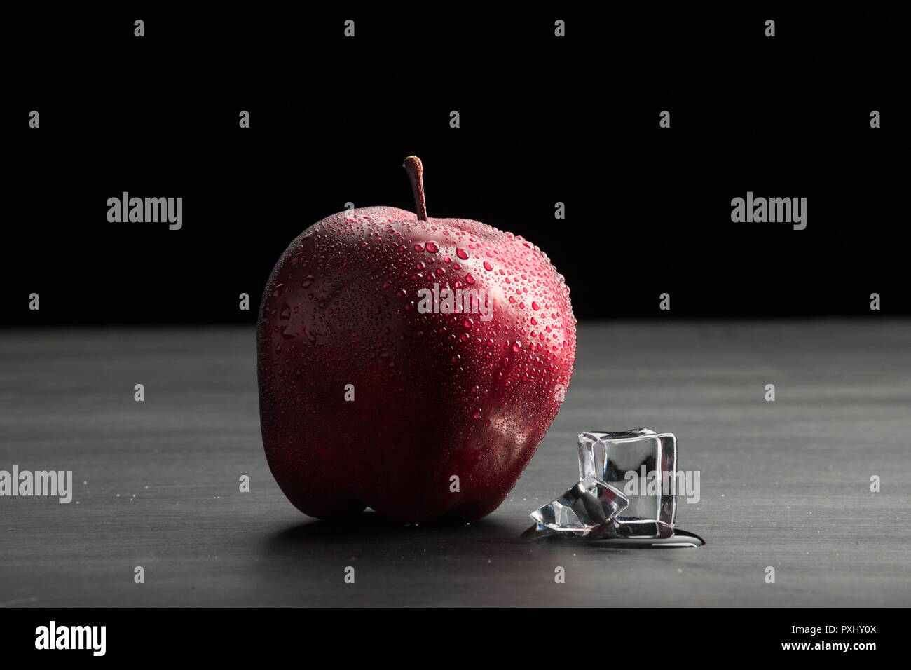 Apple and melting ice Stock Photo - Alamy