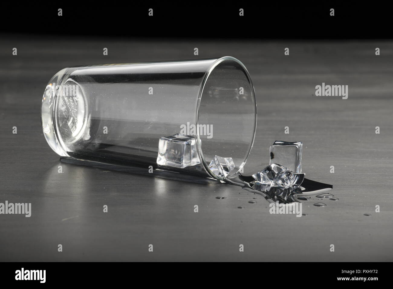 Melting ice on black surface Stock Photo - Alamy
