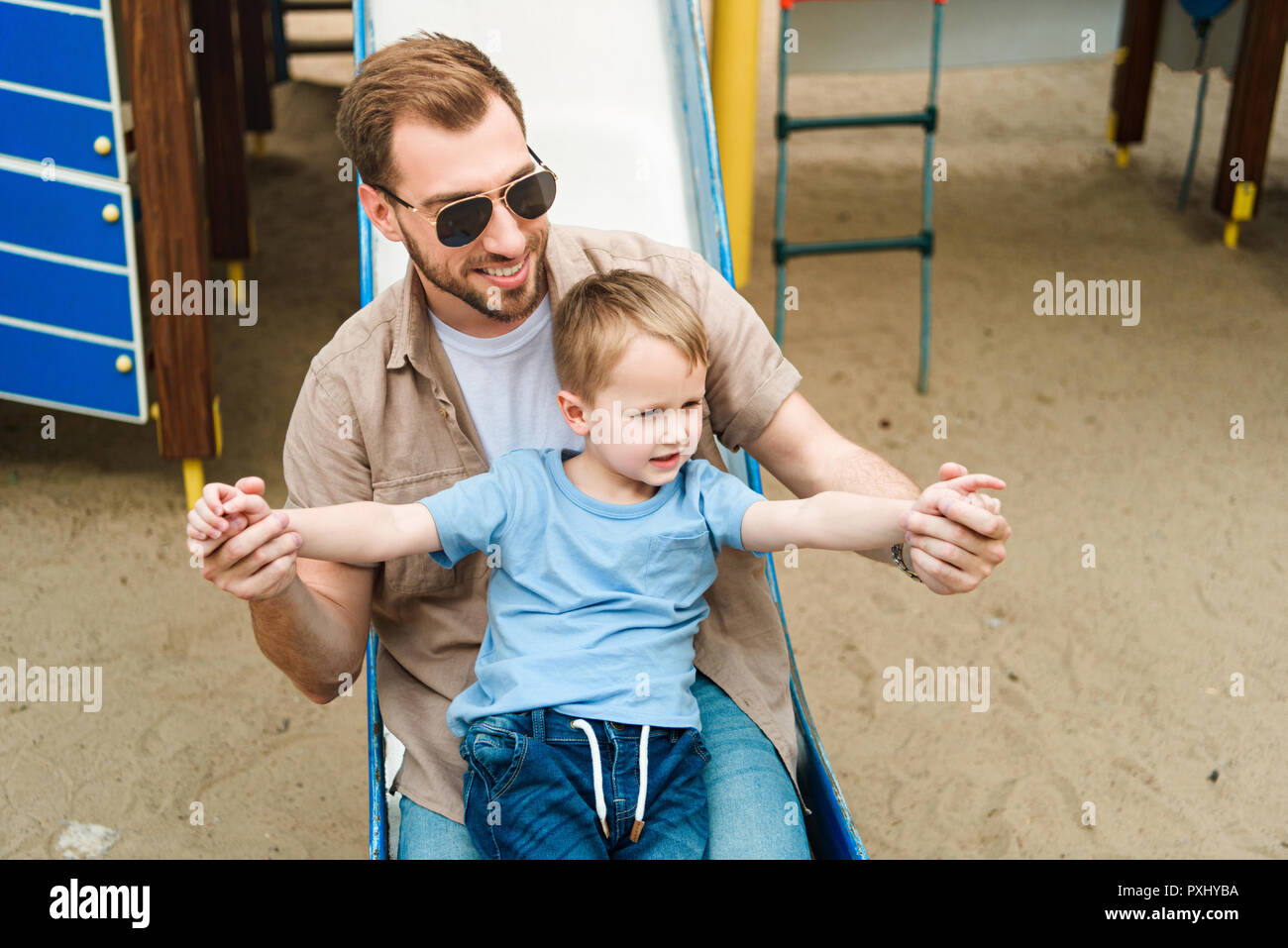 father and son having fun at playground in park Stock Photo - Alamy