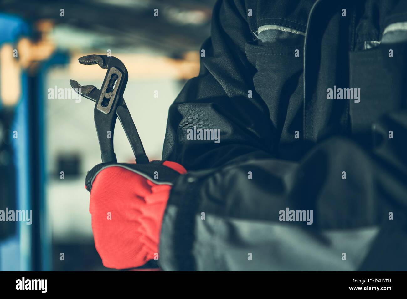 Mechanic with Iron Wrench Closeup Photo. Repairing Mechanical Issues
