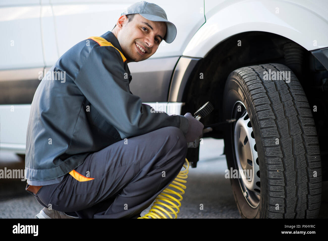 Mechanic checking the pressure of a van tire Stock Photo