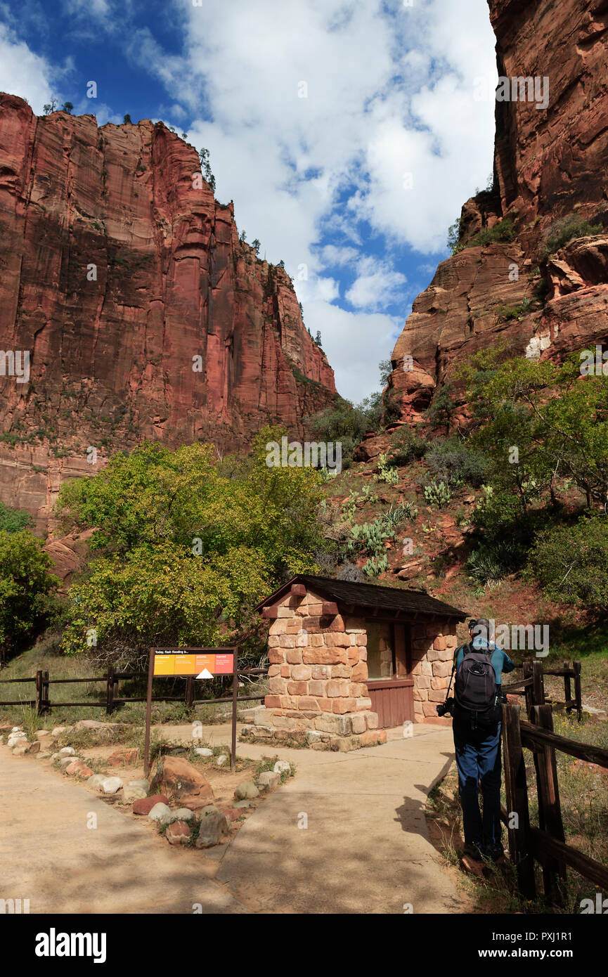 Hiker taking a picture at the gateway to Narrows, Zion National Park, Utah, USA. Stock Photo