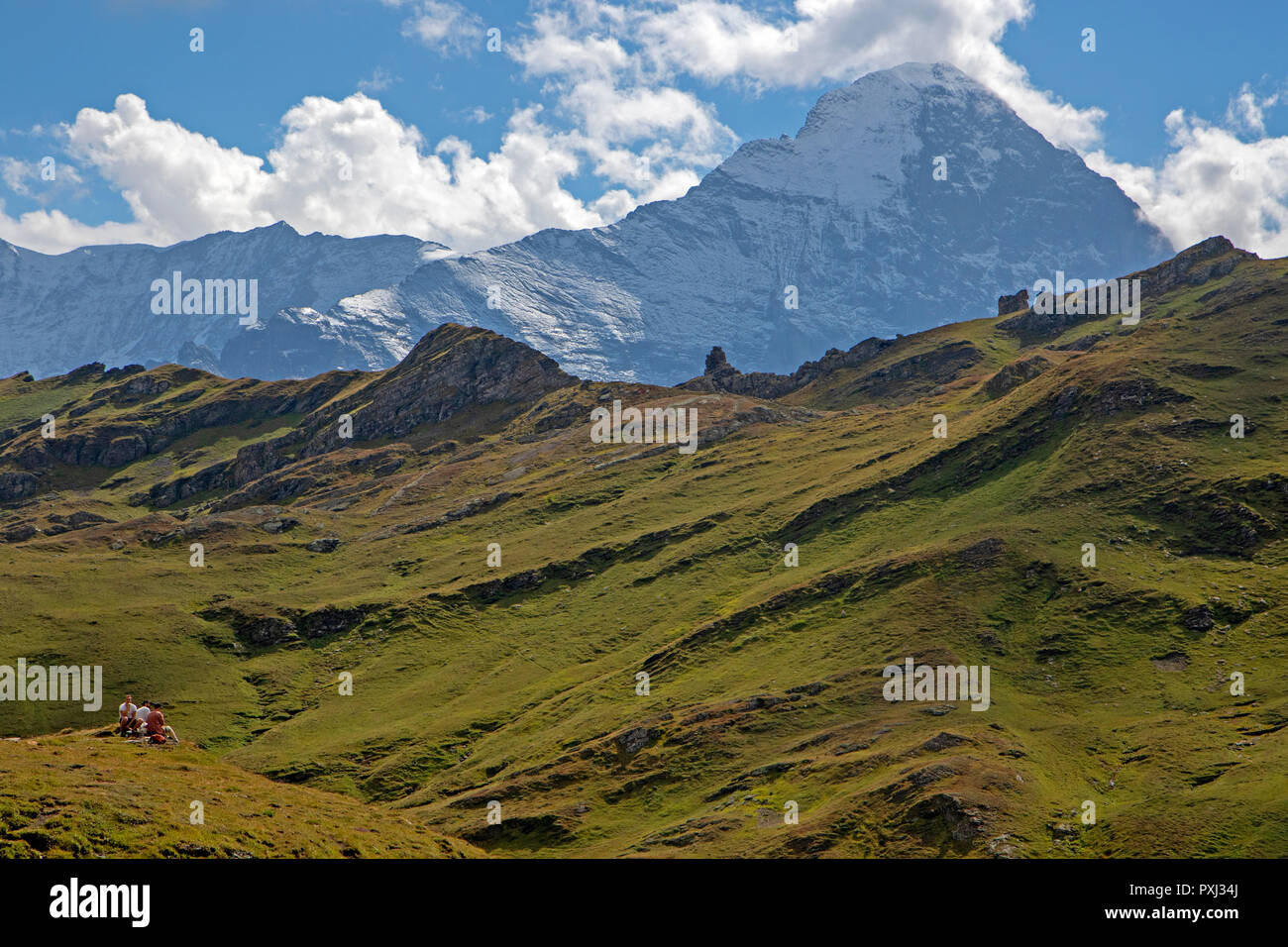 Hikers resting with a view to the Eiger Stock Photo