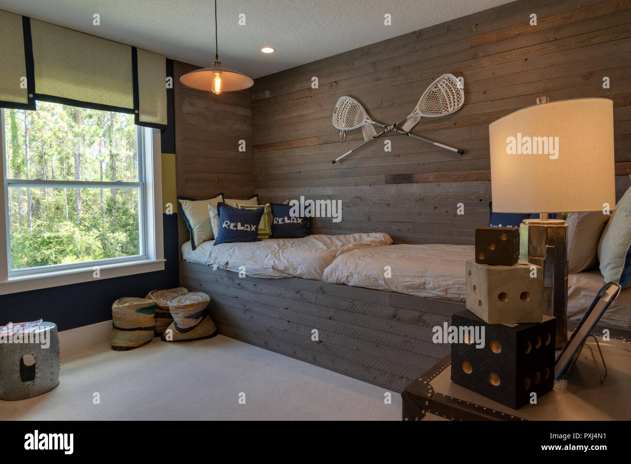 Boys bedroom with lacrosse theme with a bed and view outside Stock Photo
