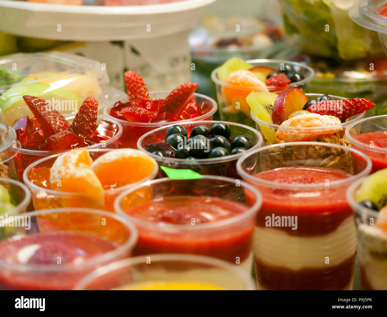 Healthy food on display, ripe fruit and yogurt, small portions in cups