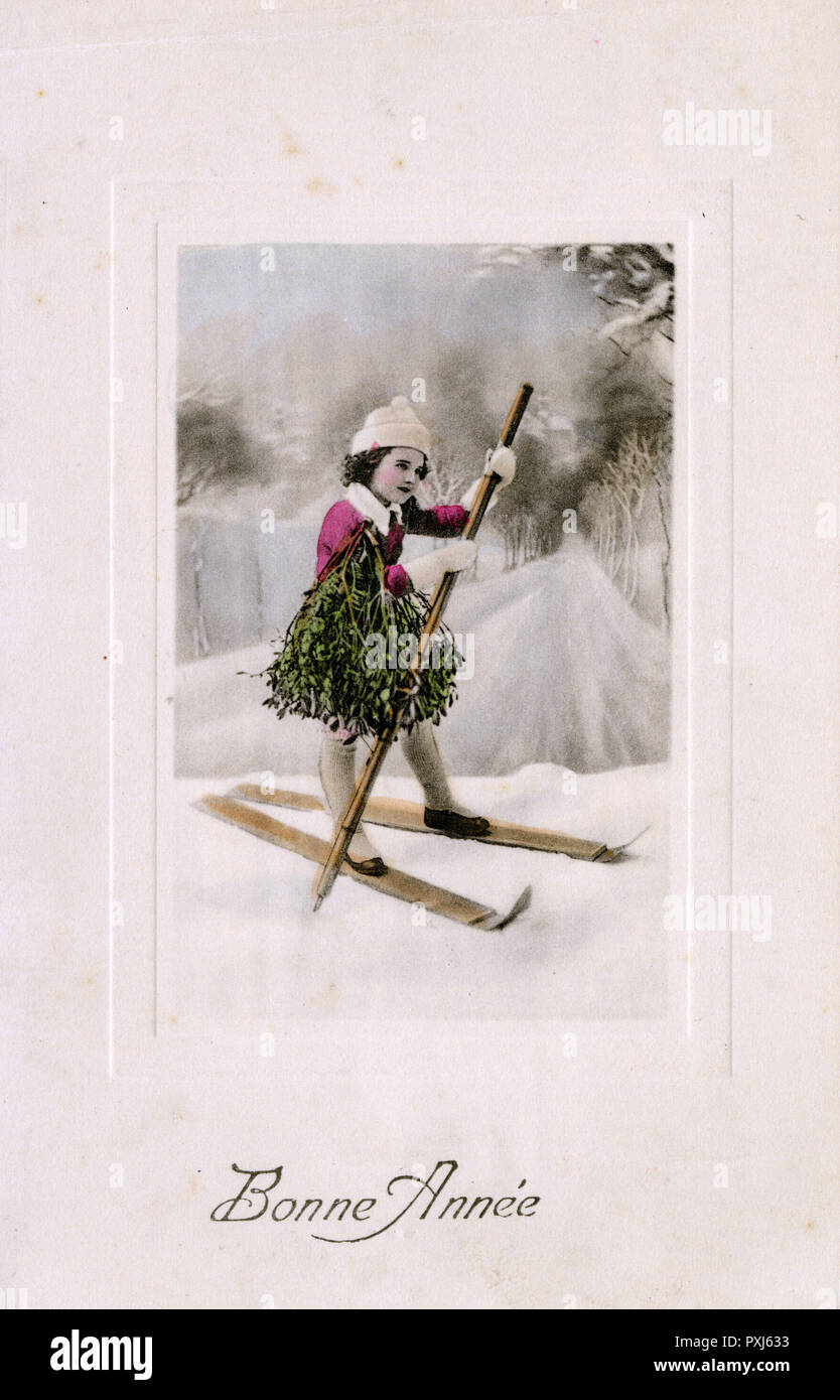 Christmas, Winter - Young girl on Skis brings home Mistletoe Stock Photo