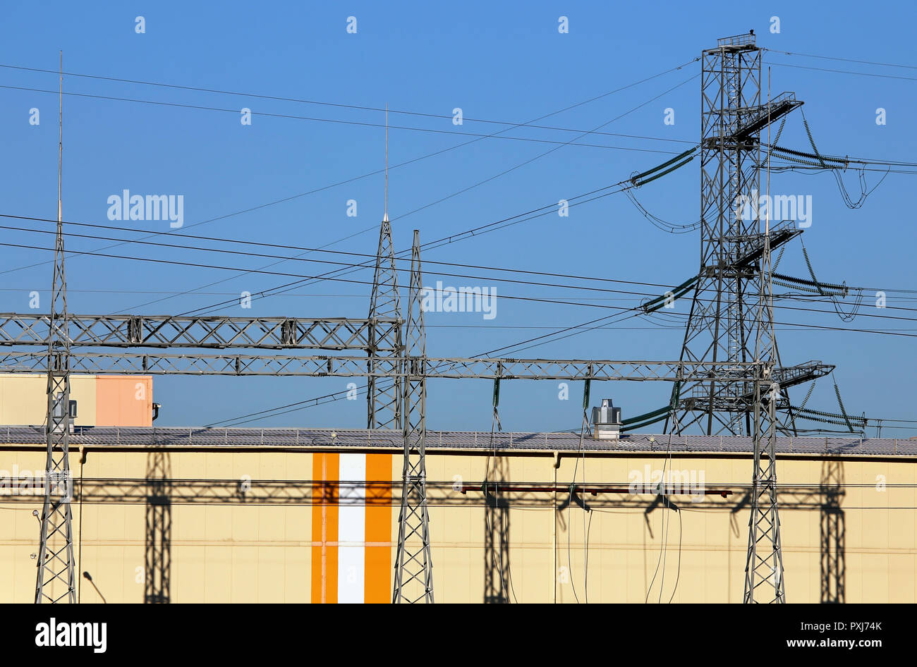 Large industrial facility with high-voltage power transmission lines Stock Photo