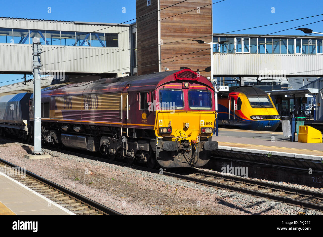 EWS Class 66 diesel locomotive heads a southbound freight through the station at Peterborough, Cambridgeshire, England, UK Stock Photo