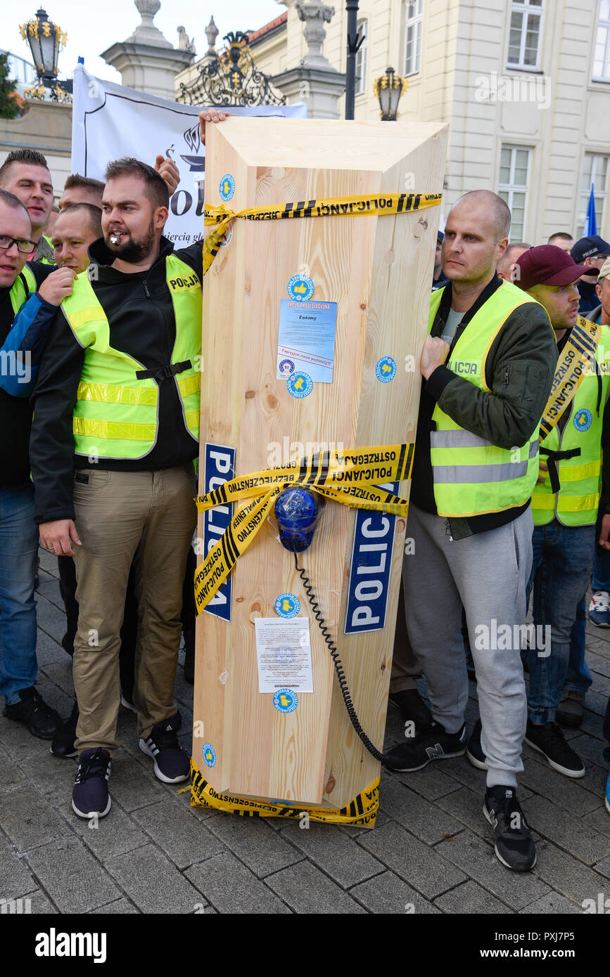 Warsaw / Poland - October.02.2018: Demonstration, national protest of police officers. Group of policeman holding coffin with police sign and neon. Stock Photo