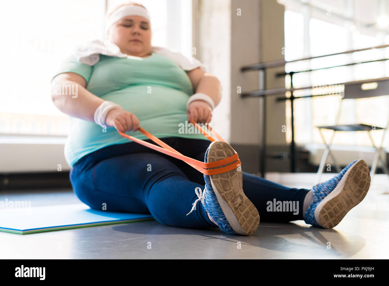 Obese Woman Training in Fitness Class Stock Photo
