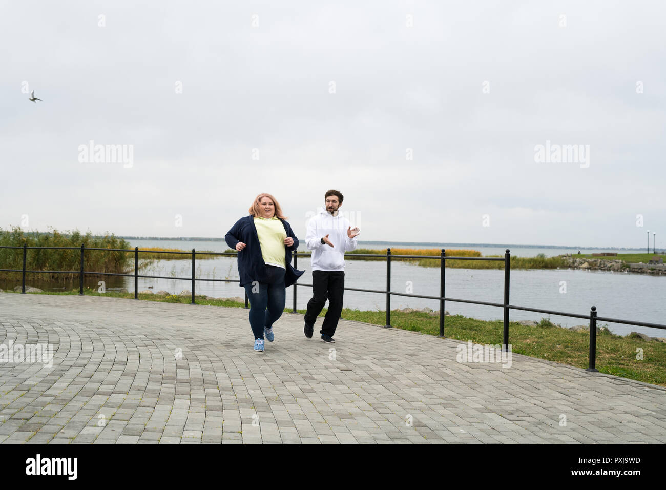 Obese Woman Running Outdoors Stock Photo