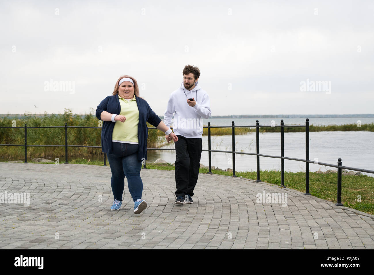 Obese Woman Jogging Outdoors Stock Photo