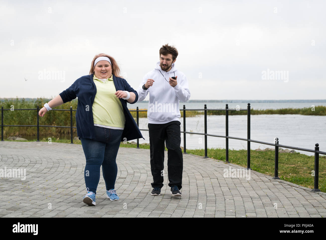 Obese Woman Running in Park Stock Photo