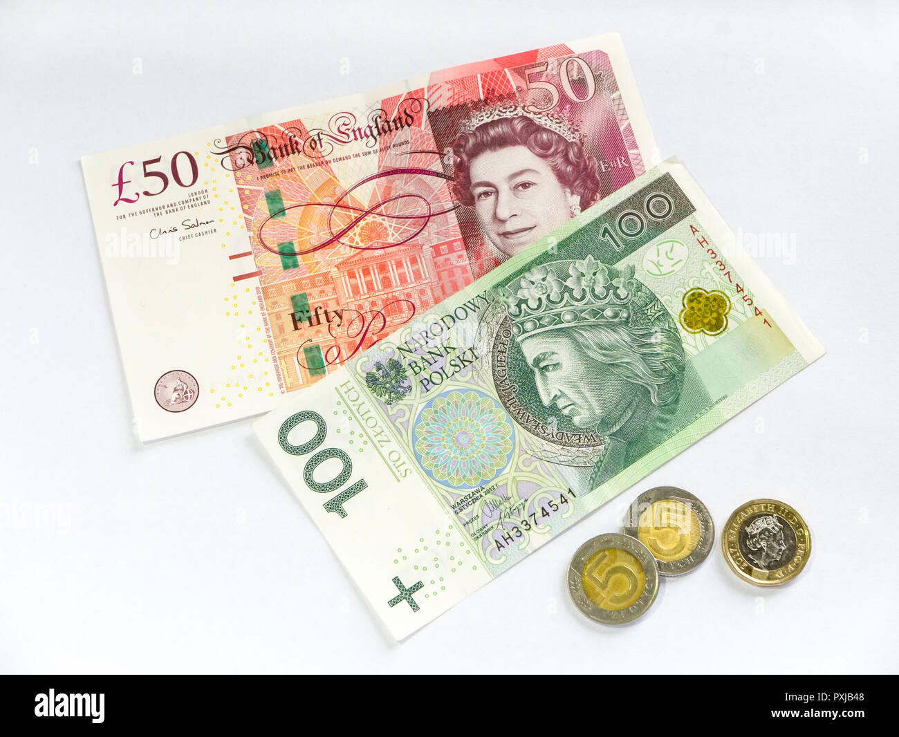 British Pound And Polish Zloty Isolated On White Background Stock Photo british-pound-and-polish-zloty-isolated-on-white-background-stock-photo