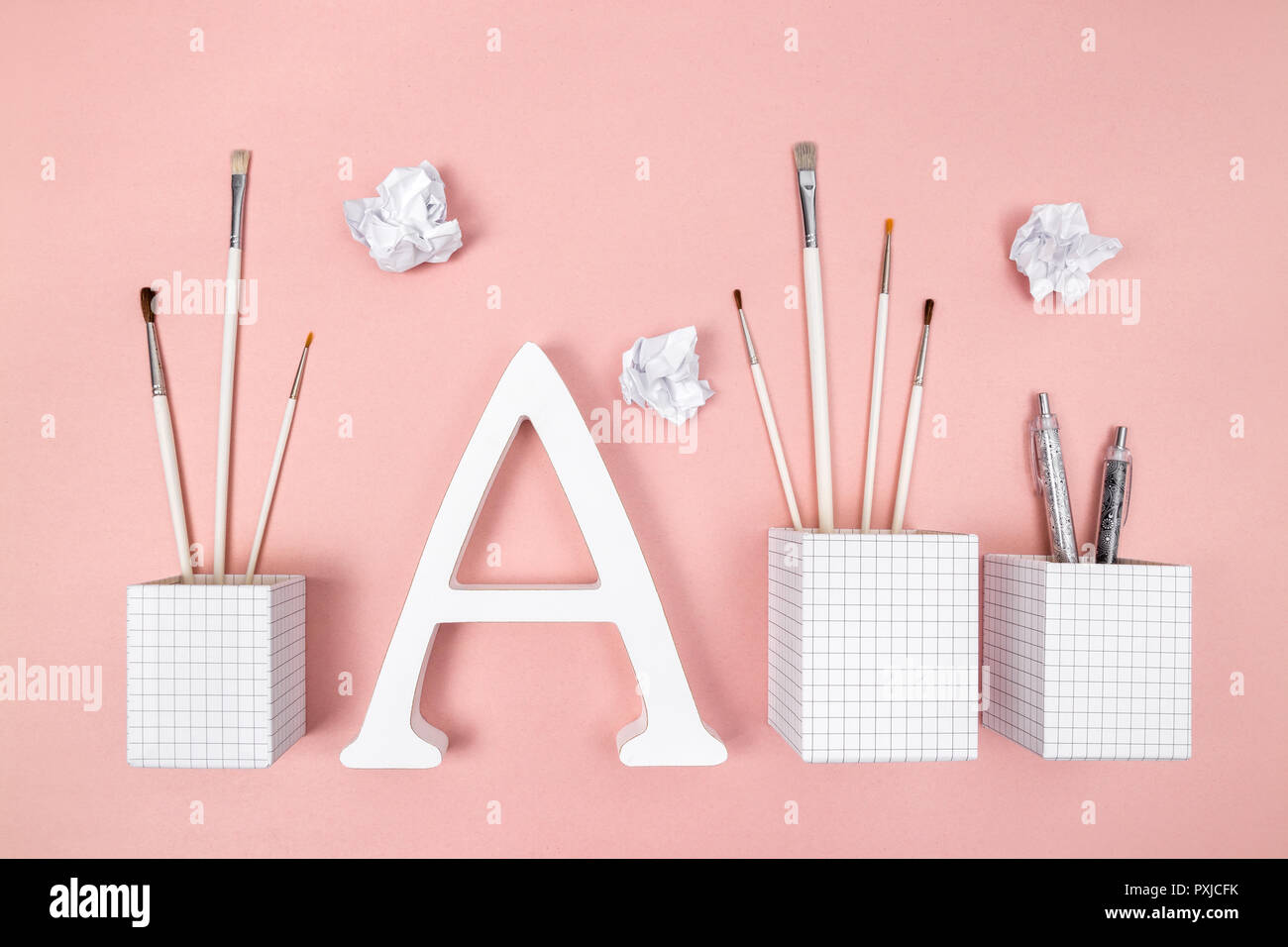 Arts, learning and creativity. Paintbrushes, letter A and crumpled