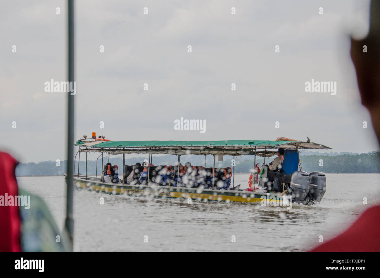 Excitement of journeying down Amazon River. Seeking adventure in remote wilderness by motorboat. Stock Photo