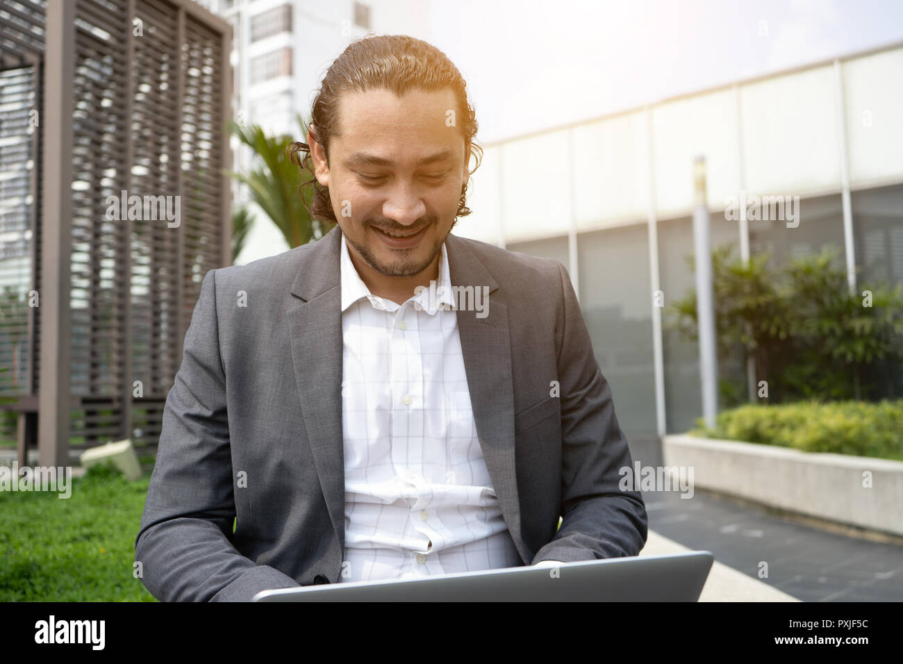 middle eastern business man using laptop outdoor Stock Photo