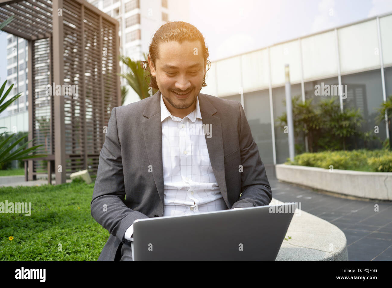 middle eastern business man using laptop outdoor Stock Photo