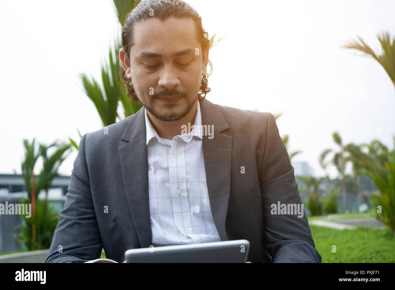 middle eastern man using tablet outdoor Stock Photo