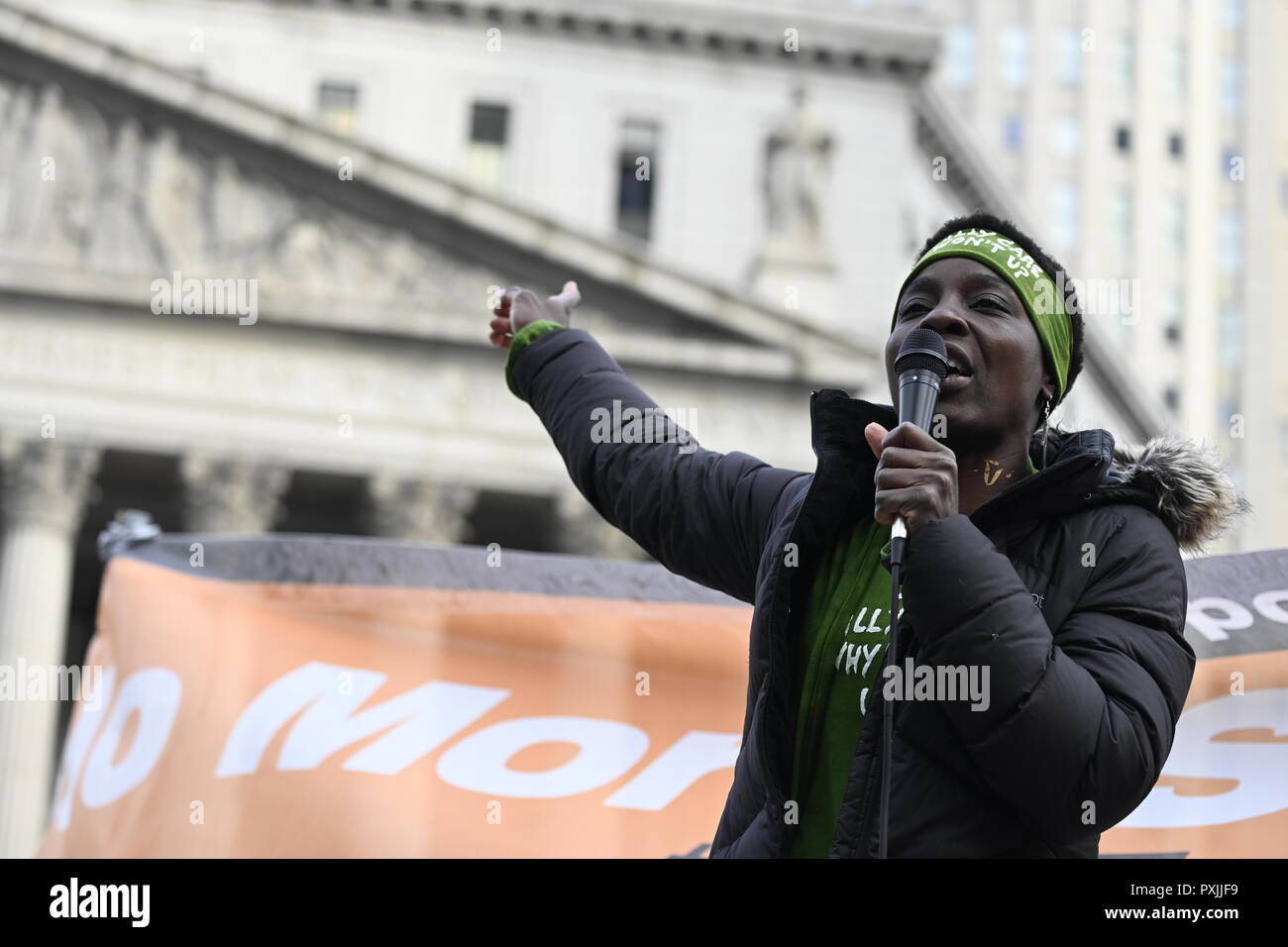 New York, USA, 22nd Oct, 2018.  Patricia Okoumou points toward the Federal courthouse where she is scheduled to be tried on Dec 17.  Okoumo spoke a a rally against police brutality at  Foley Square in lower Manhattan.  It was one of dozens of similar events scheduled in cities across the U.S. to mark the 23rd Annual National Day of Protest to Stop Police Brutality. Okoumou, a Congo native, faces trespassing and other charges after she climbed the pedestal of the Statue of Liberty on July 4, 2018, to protest Trump immigration policies. Credit: Joseph Reid/Alamy Live News Stock Photo