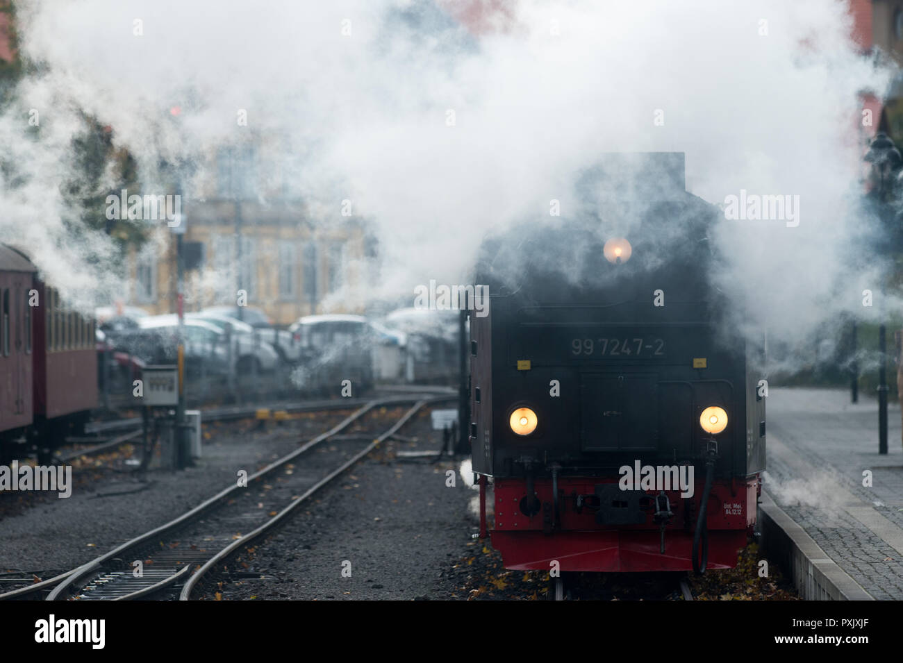 Brockengipfel, Germany. 23rd Oct, 2018. A train of the Harzer Schmalspurbahnen (HSB) pushes wagons backwards out of the station Wernigerode after the last journey. The German Weather Service (DWD) has issued a thunderstorm warning for the Harz Mountains. As a precaution, the Harz narrow-gauge railways had therefore stopped the train service to the summit of the Brocken and only drove to Drei Annen Hohne station. Credit: Klaus-Dietmar Gabbert/dpa-Zentralbild/dpa/Alamy Live News Stock Photo