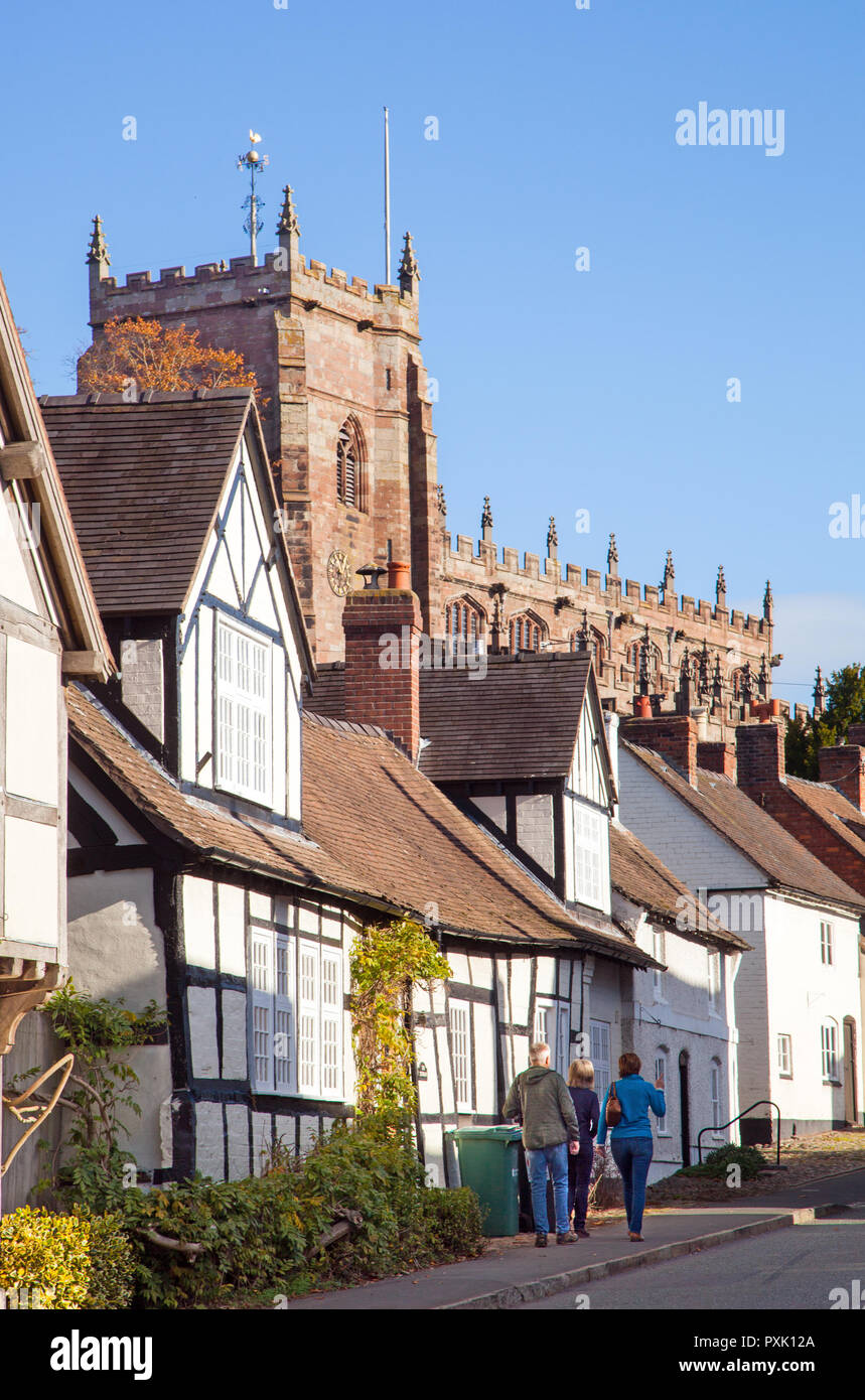 The South Cheshire market town of Malpas with black and white half timbered houses and buildings with St Oswald's parish church in the background Stock Photo