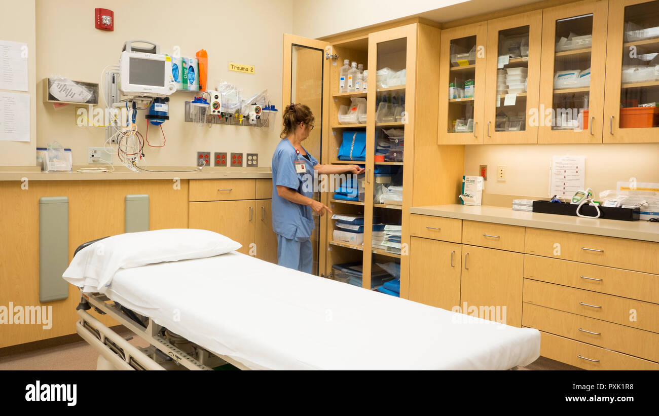 A hospital emergency room nurse stocks a cabinet with trauma supplies. Stock Photo