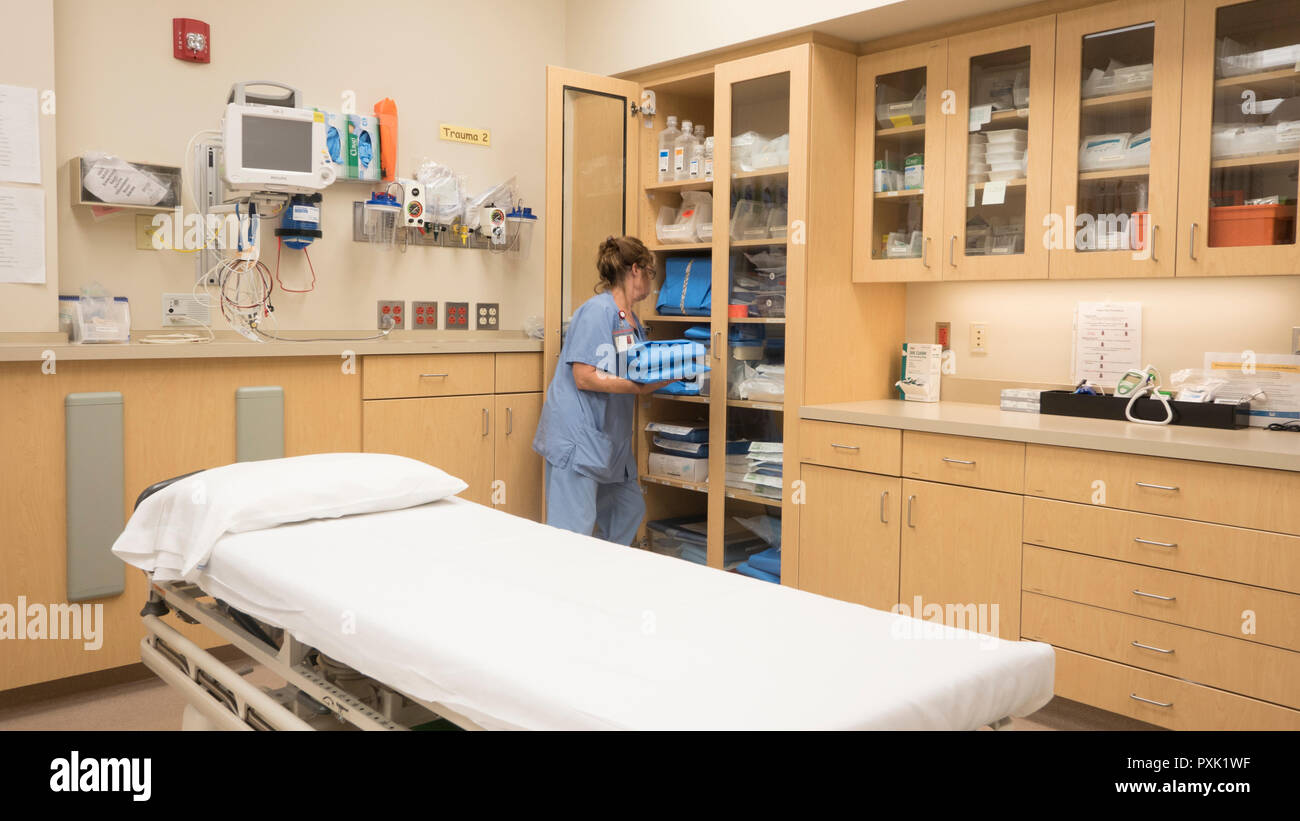 A hospital emergency room nurse stocks a cabinet with trauma supplies. Stock Photo