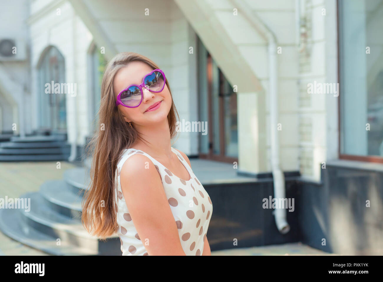 Teen girl with heart-shaped sunglasses smiling Stock Photo - Alamy