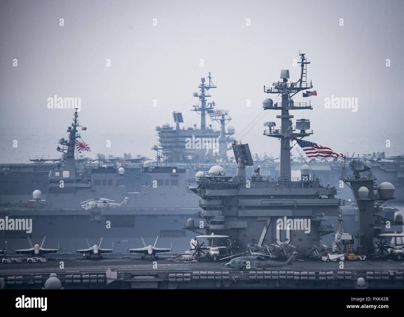 SEA OF JAPAN (June 1, 2017) The Carl Vinson strike group, including USS Carl Vinson (CVN 70), Carrier Air Wing (CVW) 2, guided-missile cruiser USS Lake Champlain (CG 57) and guided-missile destroyers USS Wayne E. Meyer (DDG 108) and USS Michael Murphy (DDG 112), operates with the Ronald Reagan strike group including, USS Ronald Reagan (CVN 76), Carrier Air Wing (CVW) 5, guided-missile cruiser USS Shiloh (CG 67), guided-missile destroyers USS Barry (DDG 52), USS McCampbell (DDG 85), USS Fitzgerald (DDG 62), and USS Mustin (DDG 89) and the Japanese Ships (JS) Hyuga (DDH 181) and JS Ashigara (DDG Stock Photo