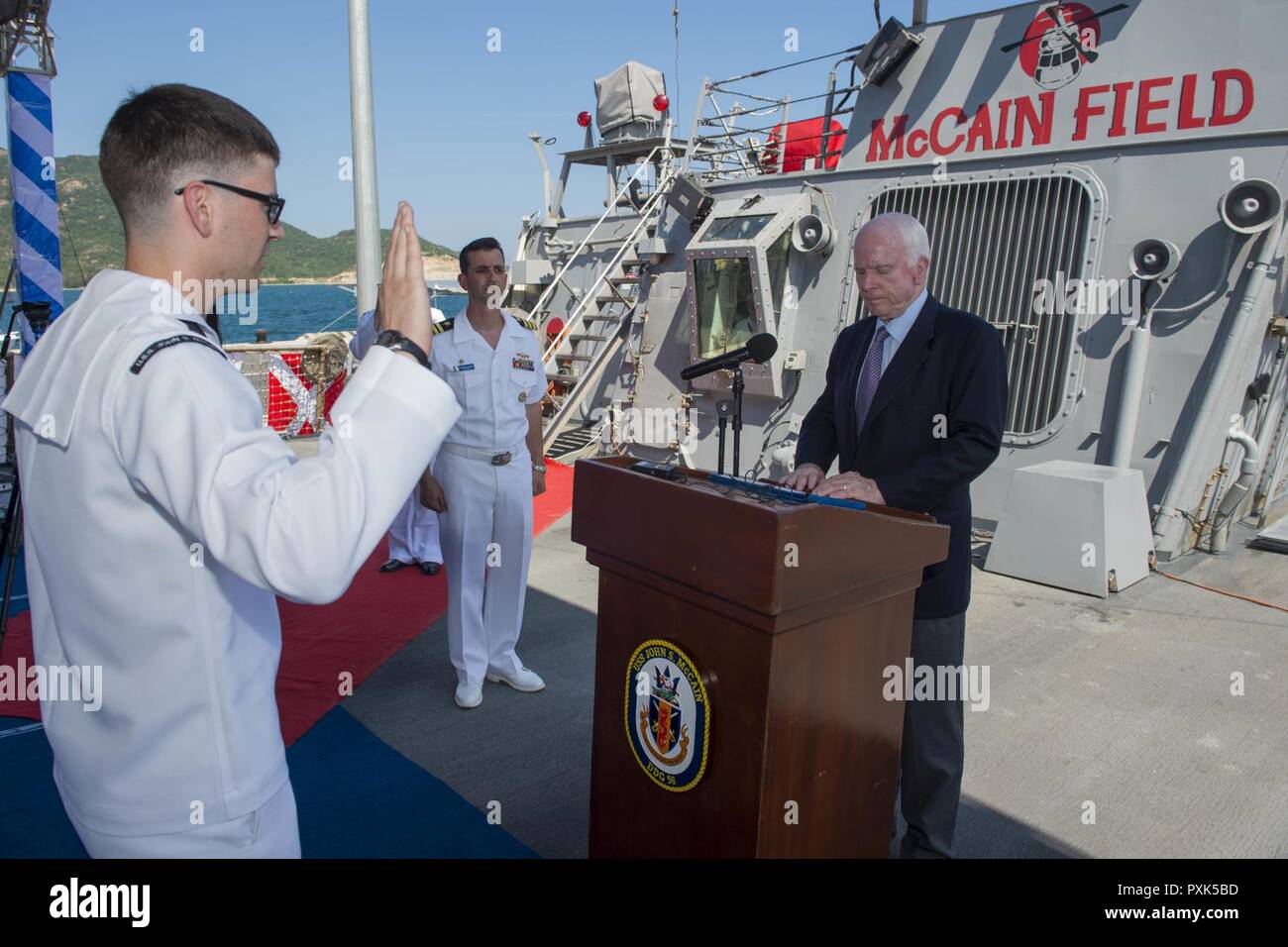 CAM RANH, Vietnam (Jun. 2, 2017) Senator John S. McCain III reenlists Electronics Technician 2nd Class Michael Papapietro, the Arleigh Burke-class guided-missile destroyer USS John S. McCain (DDG 56) sailor of the year, aboard the ship in the western Pacific. The U.S. Navy has patrolled the Indo-Asia-Pacific routinely for more than 70 years promoting regional peace and security. Stock Photo