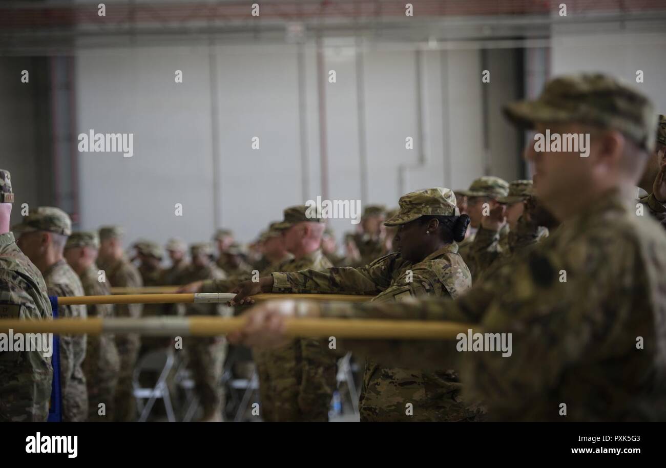 Airmen from the 455th Air Expeditionary Wing lower their group guidons as the national anthem is sung during a change of command ceremony at Bagram Airfield, Afghanistan, June 3, 2017. During the ceremony, Brig. Gen. Jim Sears relinquished command of the 455th AEW to Brig. Gen. Craig Baker. Stock Photo