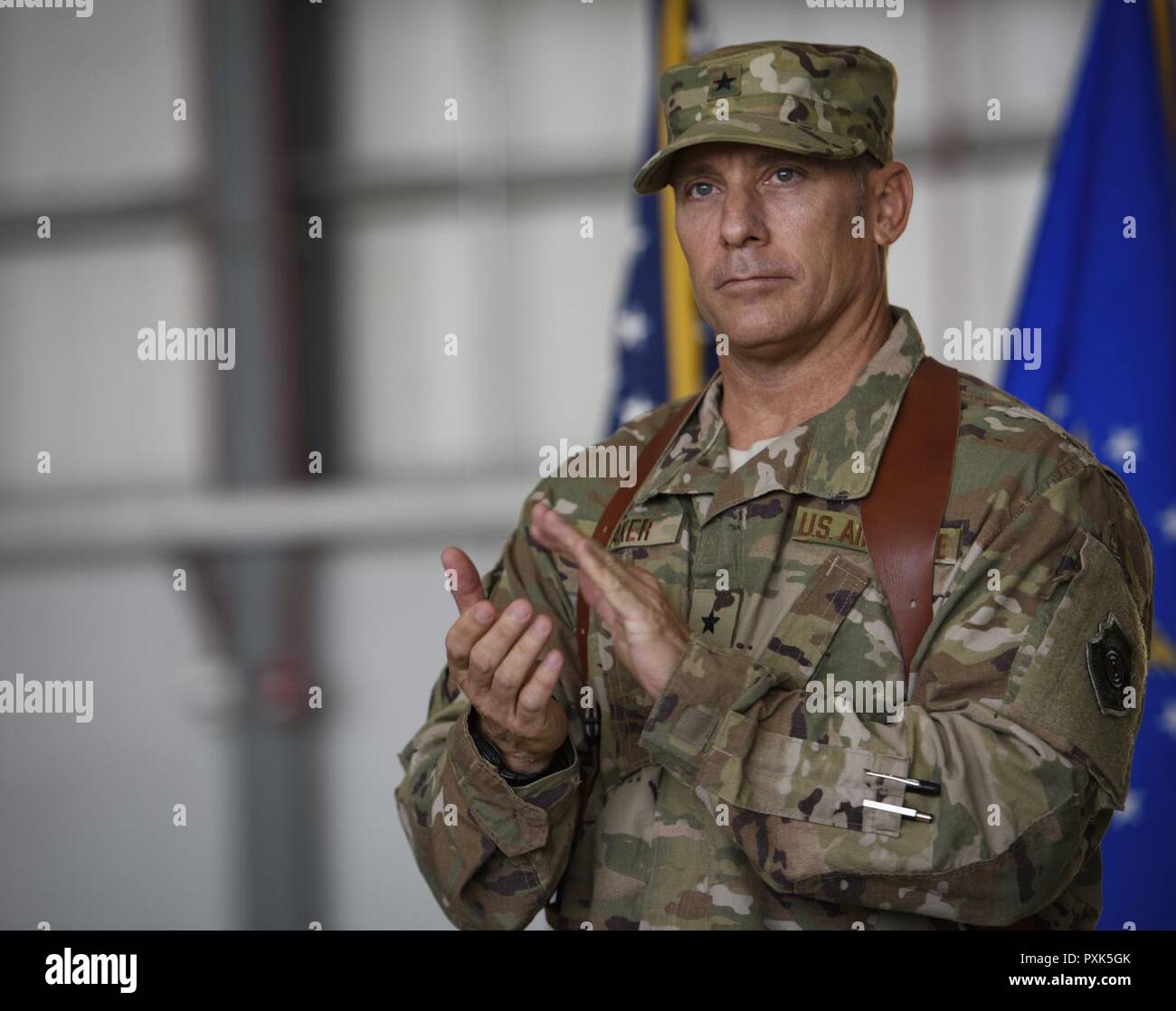 Brig. Gen. Craig Baker, the 455th Air Expeditionary Wing commander, gives a round of applause during a change of command ceremony at Bagram Airfield, Afghanistan, June 3, 2017. As the commander of the 455th AEW, Baker will lead the premier counterterrorism air mission in Afghanistan. The wing’s operations enable the NATO Resolute Support mission to successfully train, advise, and assist the military and security forces of Afghanistan, while restricting and deterring the terrorist threat in the region. Stock Photo