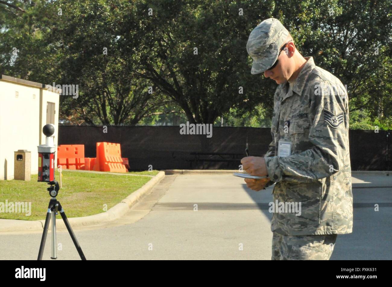Staff Sgt. Casey Crump records readings from a Wet Bulb Globe Temperature at Seymour Johnson Air Force Base during a June exercise. The WBGT instument is used to determine relative humidity and  outside temperature. It also helps monitor flag readings to determine how long service members can stay outside before getting overheated. Stock Photo