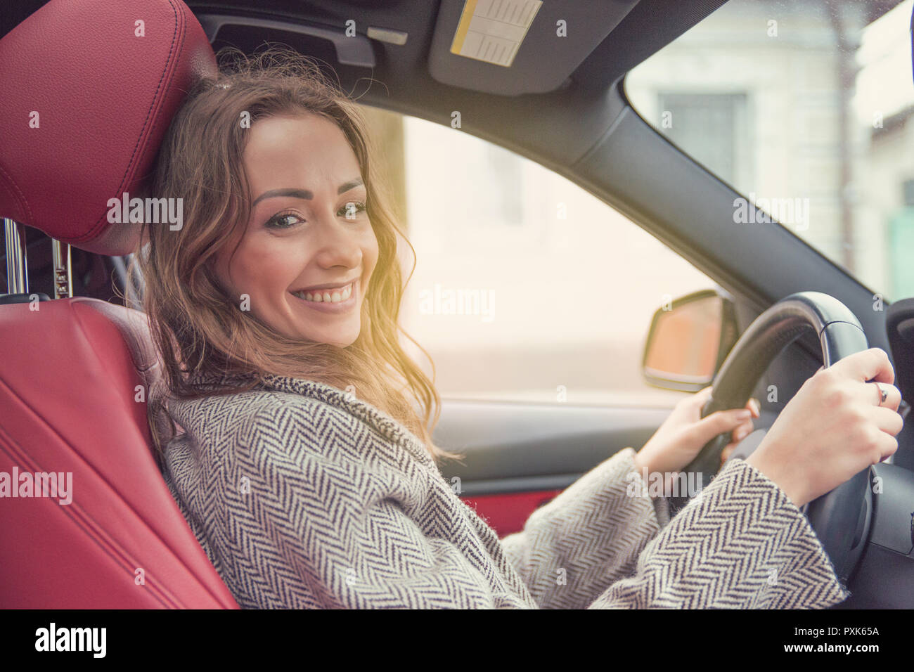 Young smiling woman driving a modern car Stock Photo