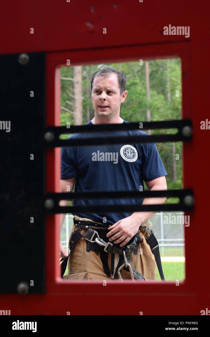 Staff Sgt. Joshua Linder, a 125th Civil Engineering Squadron firefighter, conducts forcible entry training at Naval Air Station Jacksonville, Fla., June 2, 2017. Forcible entry is a method of gaining access via halligan bars, axes, or sledgehammers. Stock Photo