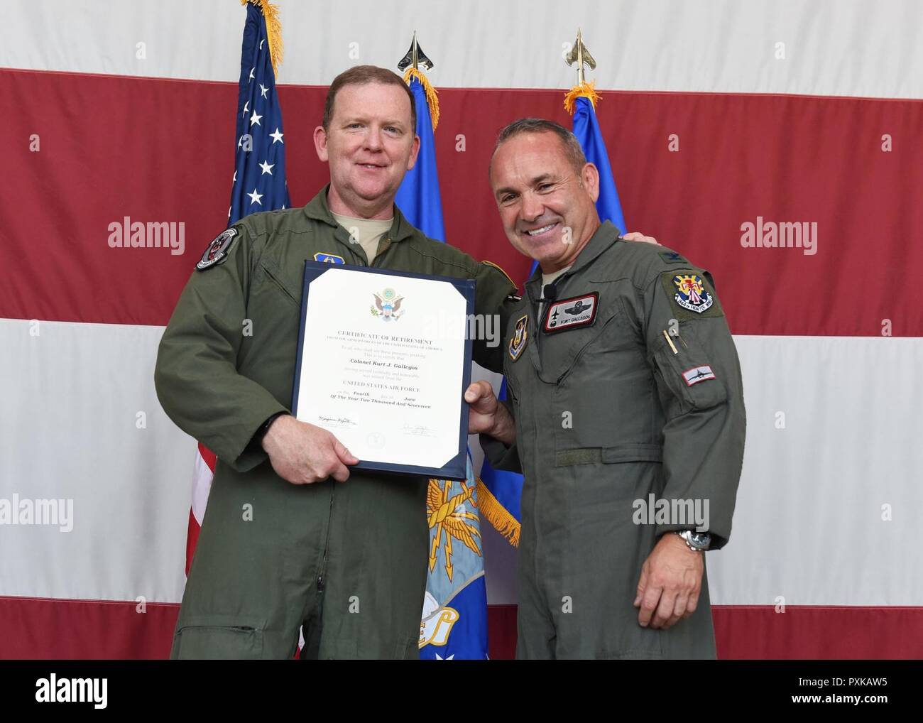 Maj. Gen. Richard Scobee, Air Force Reserve Command vice commander, and Col. Kurt Gallegos, the former 944th Fighter Wing commander, pose with Gallegos’ retirement certificate June 3 during the retirement ceremony at Luke Air Force Base, Arizona. Stock Photo