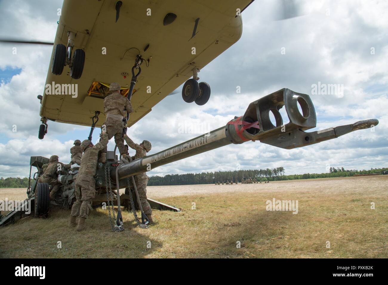 Battle Group Poland U.S. Soldiers, assigned to Bulldog Battery, 2nd Squadron, 2nd Cavalry Regiment, along with 10th Mountain Combat Aviation Brigade, conduct sling load and air assault training with M777A2 Howitzers, during Saber Strike 2017, at Bemowo Piskie Training Area near Orzysz, Poland, June 7, 2017. Saber Strike17 is a U.S. Army Europe-led multinational combined forces exercise conducted annually to enhance the NATO alliance throughout the Baltic region and Poland. This year's exercise includes integrated and synchronized deterrence-oriented training designed to improve interoperabilit Stock Photo